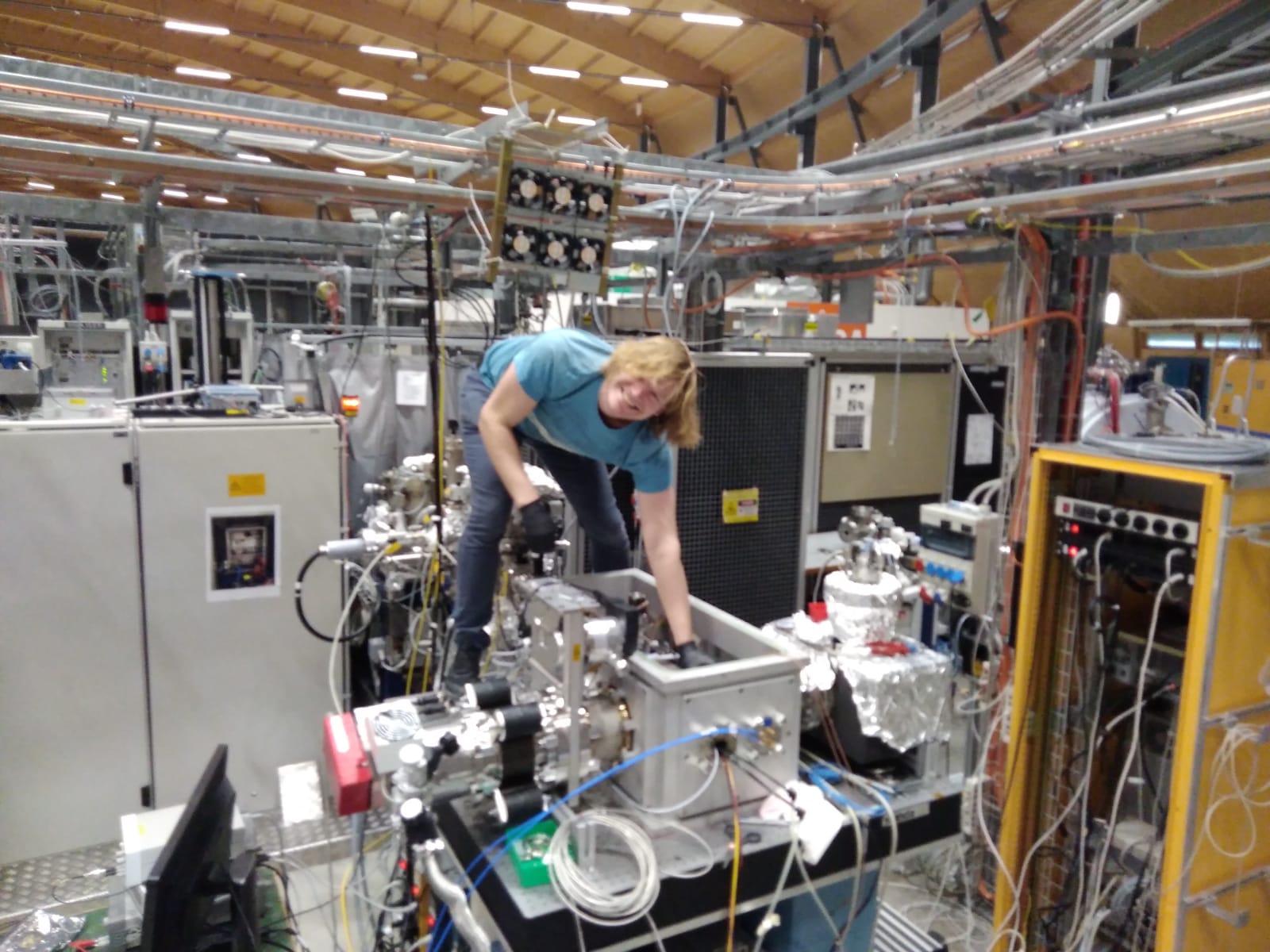 A person is standing on top of a mechanical structure